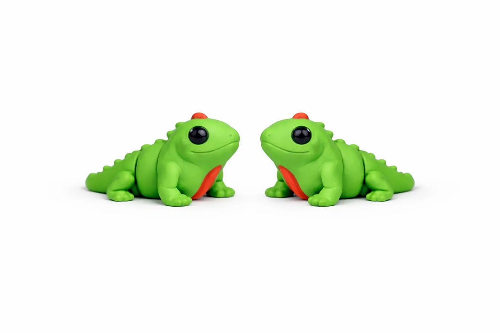 Two green toy iguanas on a white background