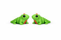 Two green toy iguanas on a white background