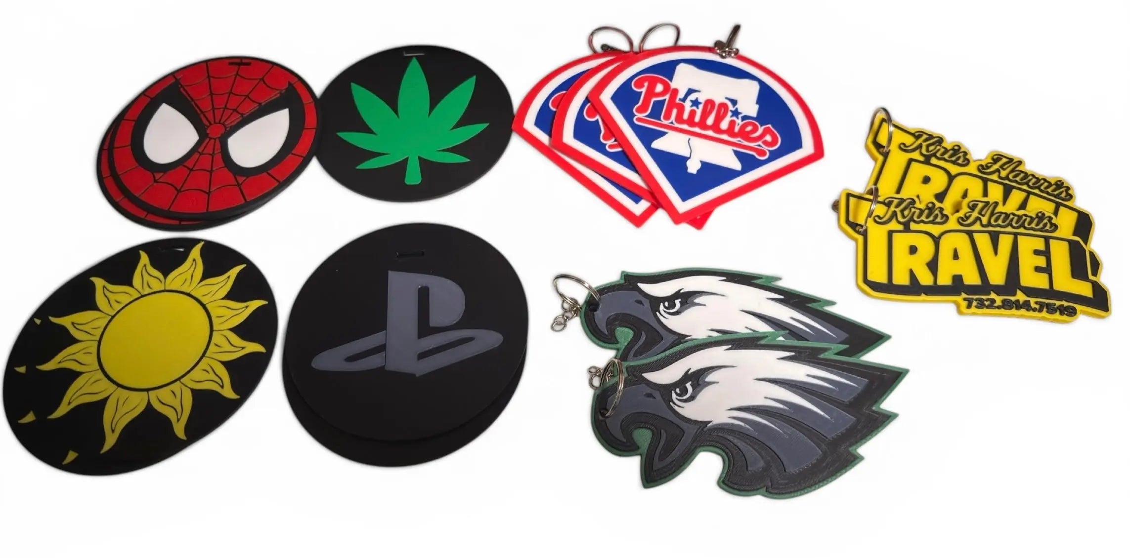Collection of various custom 3d printed luggage tags on a white background