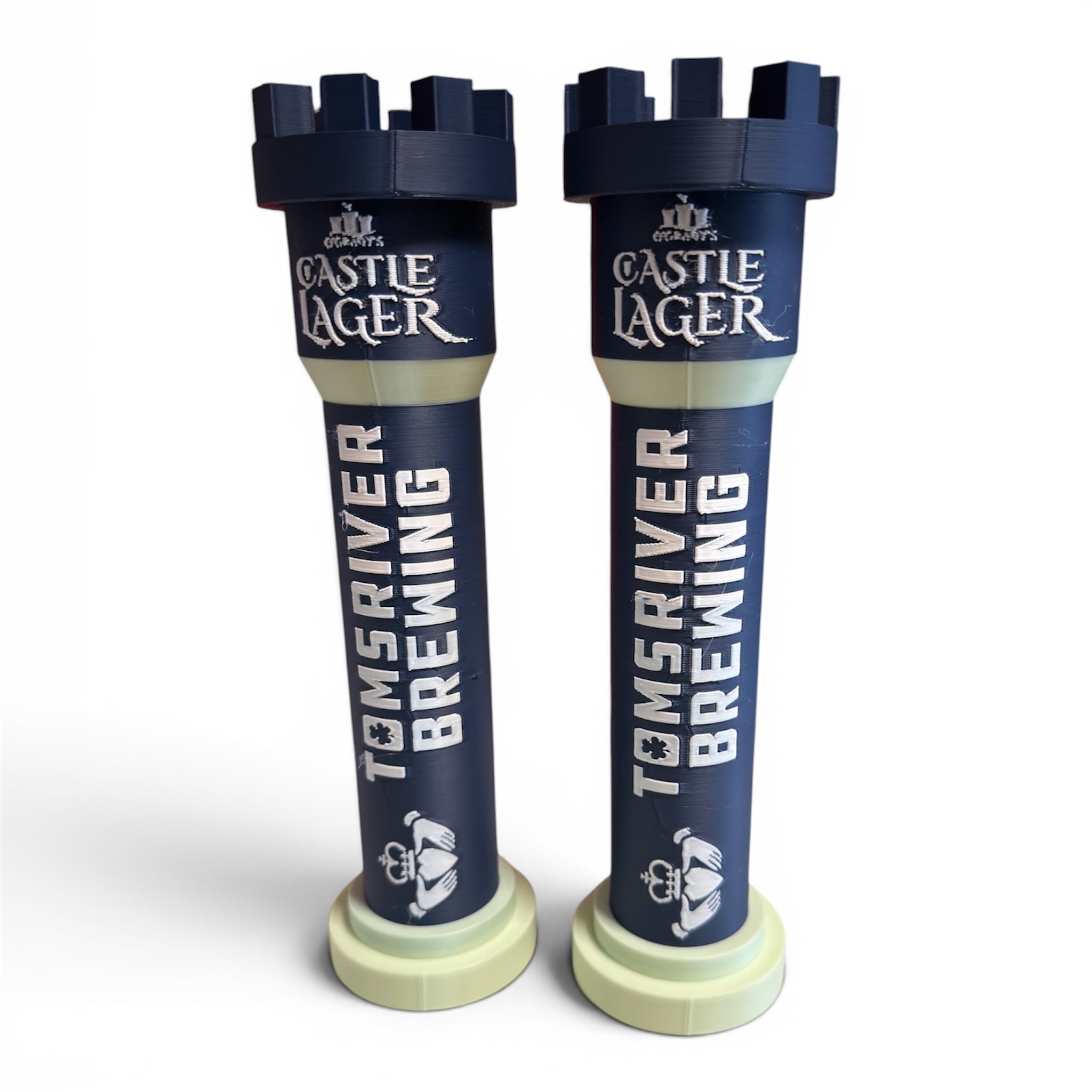 Two Castle Lager beer tap handles with Toms River Brewing branding on a white background