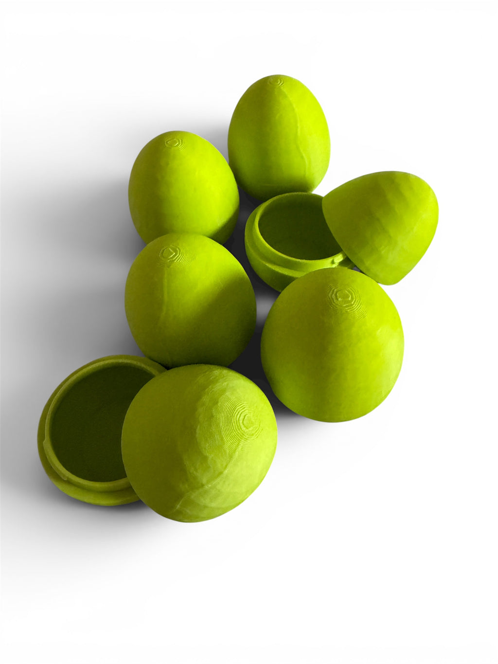 Green 3d printed eggs on a white background