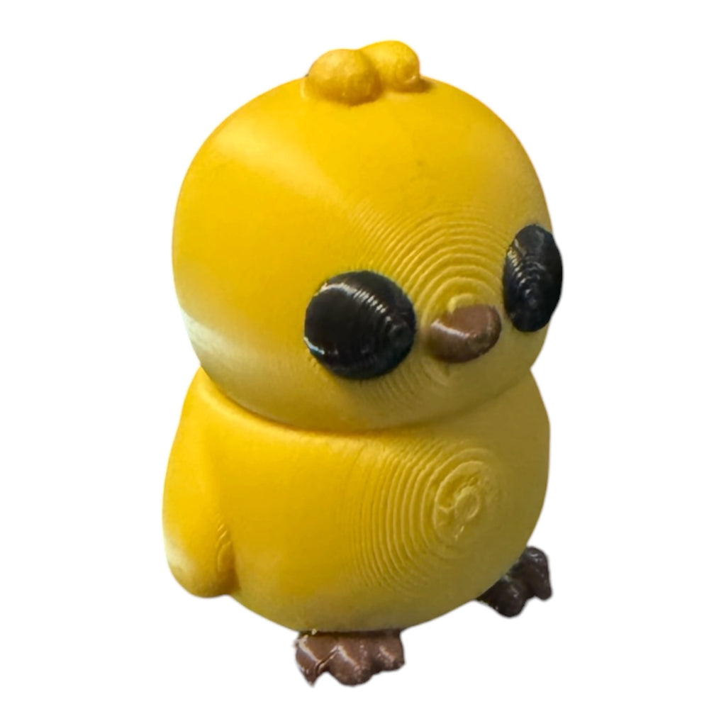 Colorful Flexi Chick toy from Driftwood 3D Printworks, flexible plastic figure with vibrant yellow and orange hues.