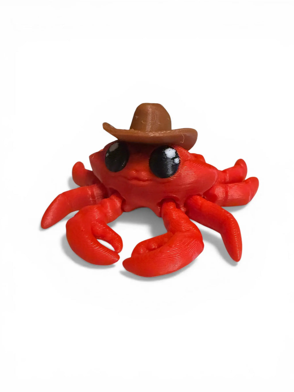 Red crab figurine wearing a brown cowboy hat on a white background