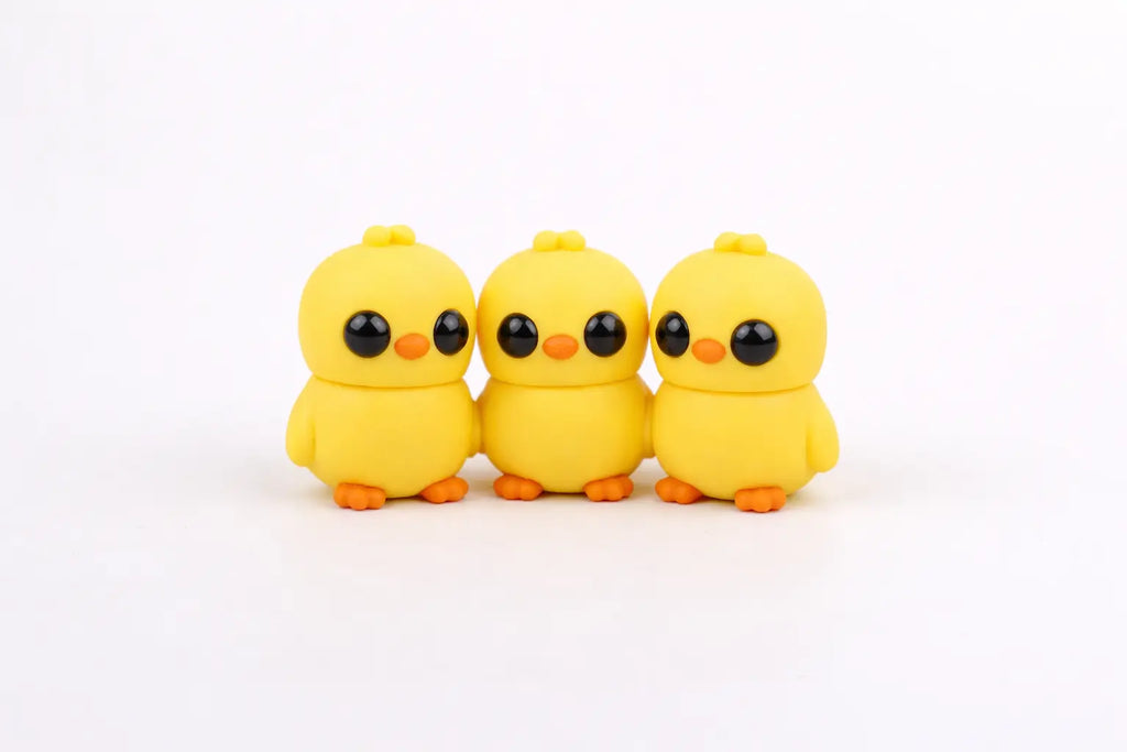 Three yellow flexi chicks on a white background