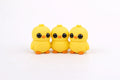 Three yellow flexi chicks on a white background