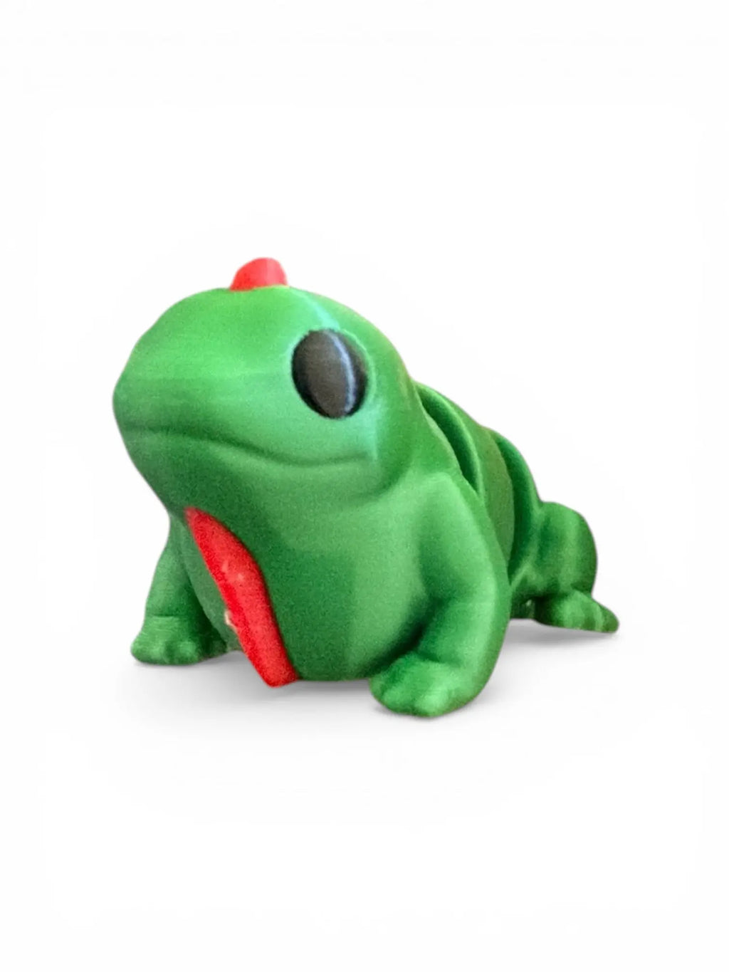 Green toy iguana on a white background