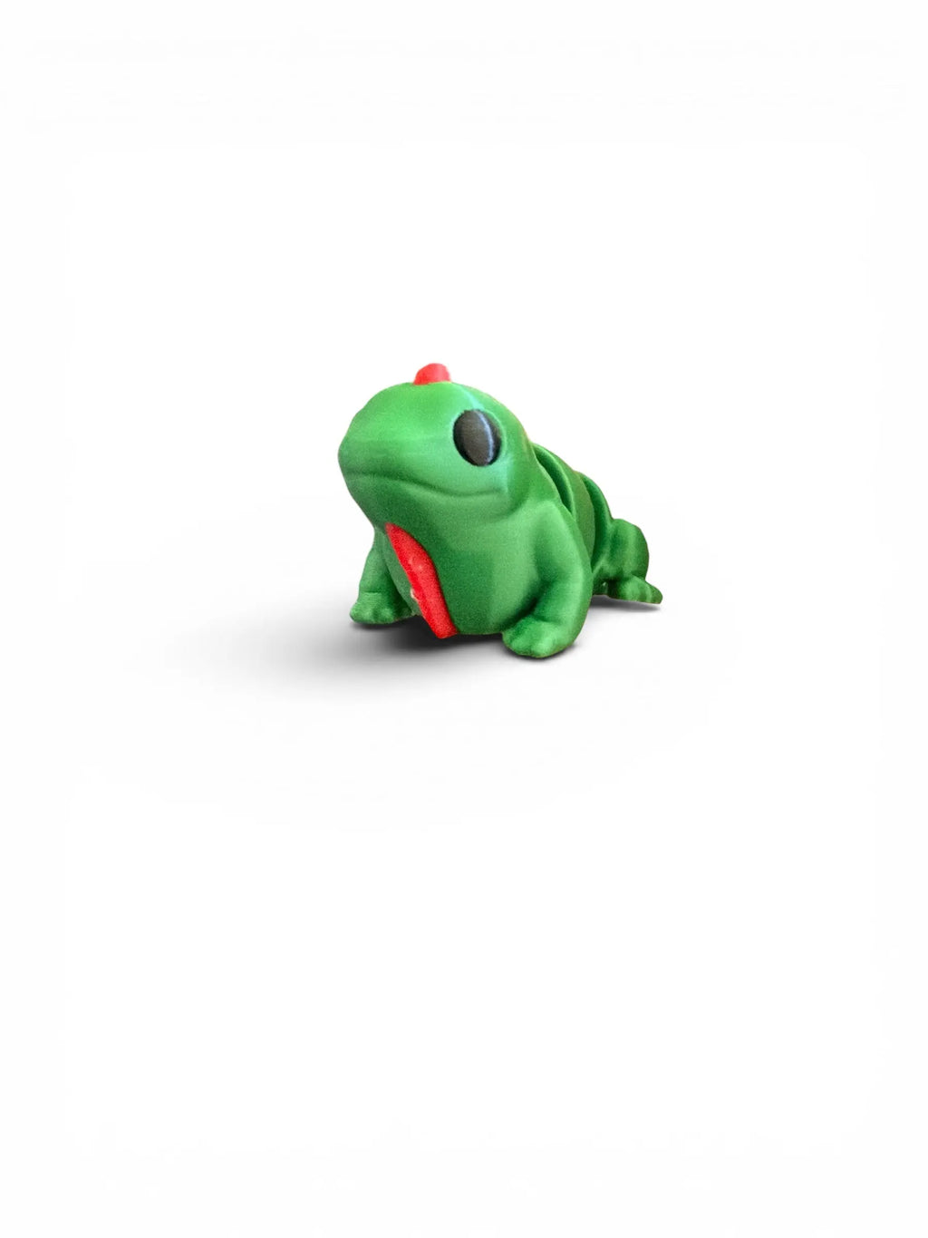 Green toy iguana on a white background