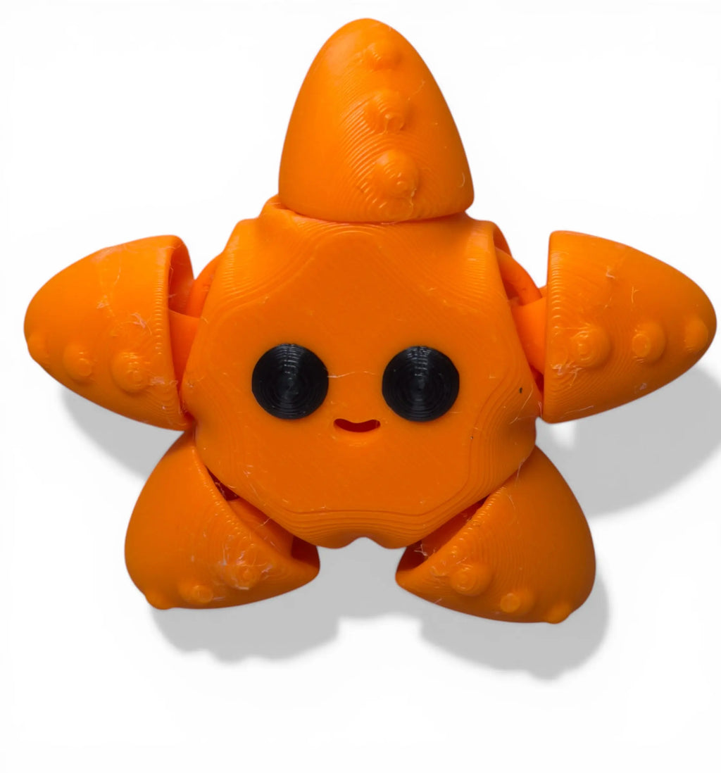 Orange star fish flexi with black eyes on a white background