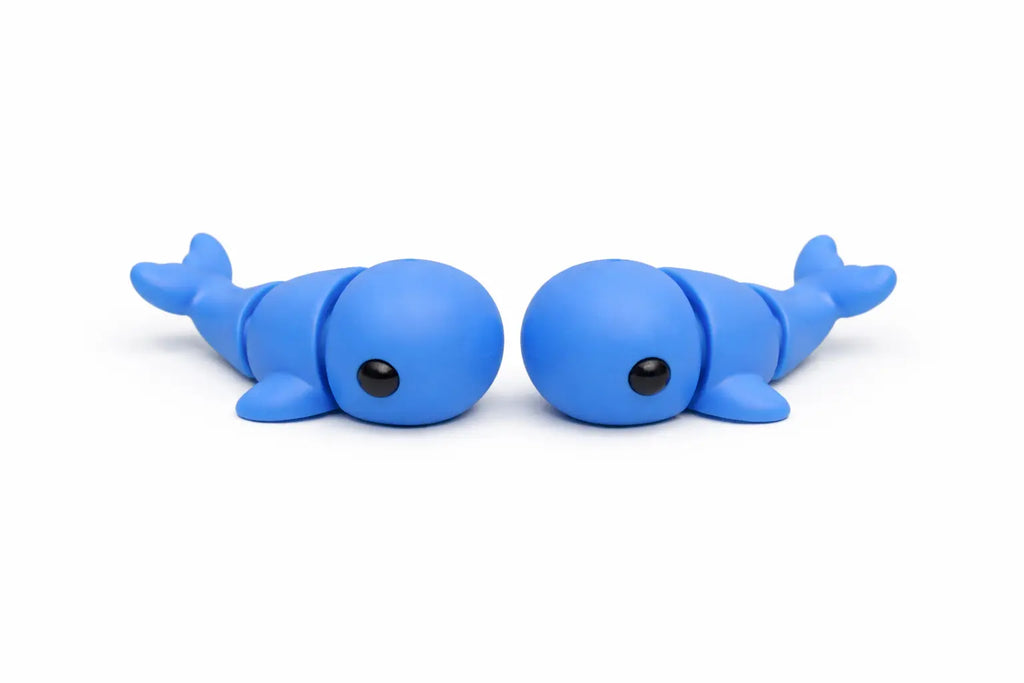 Two blue flexi whales on a white background