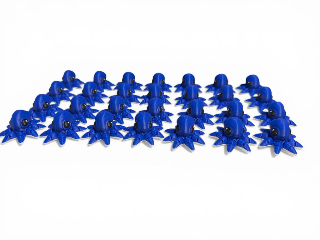 Multiple blue 3d printed octopus arranged in a pattern on a white background