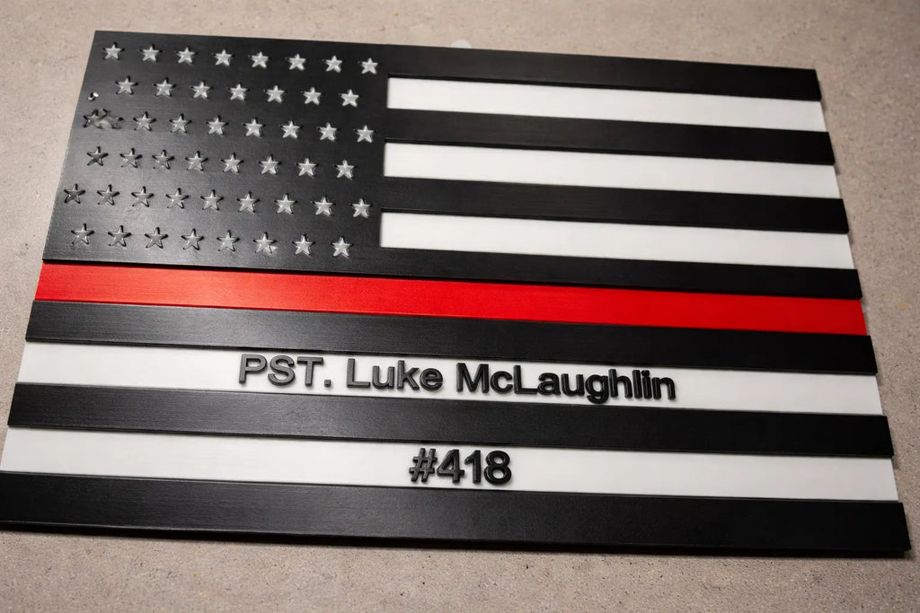 American flag with a red stripe and text on a gray surface