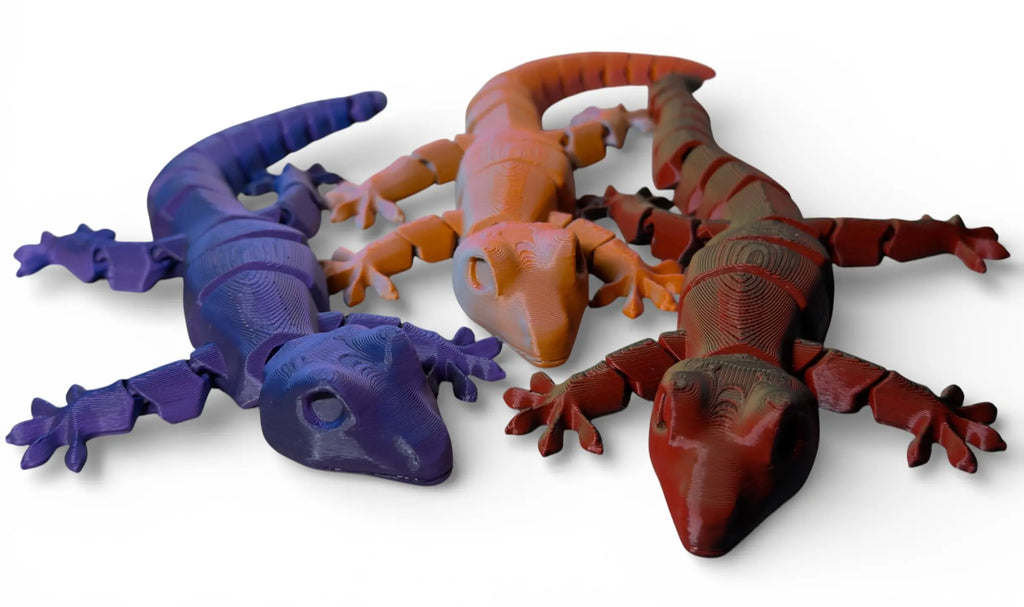 Three colorful gecko flexis on a white background
