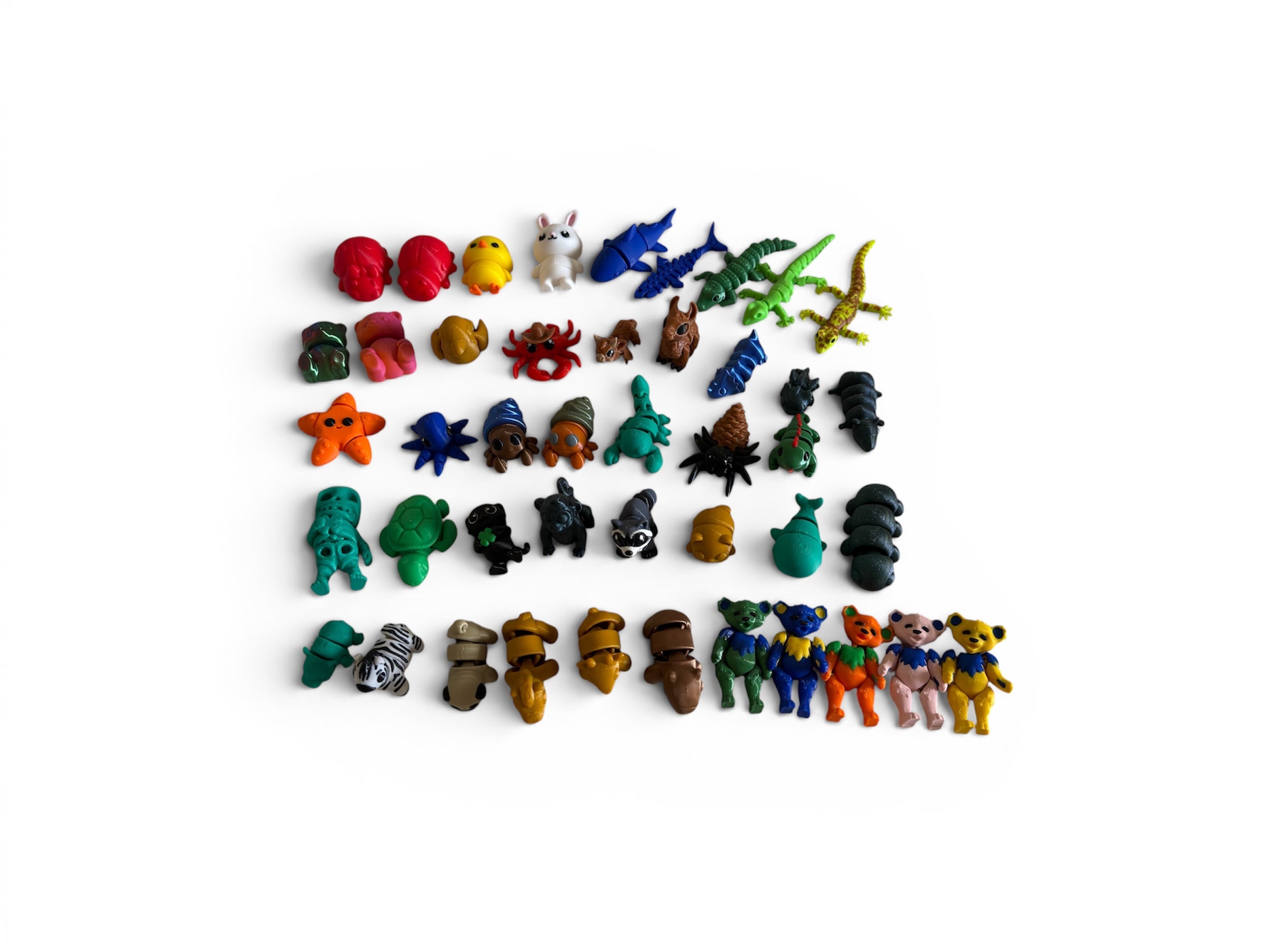 Collection of small colorful figurines on a white background
