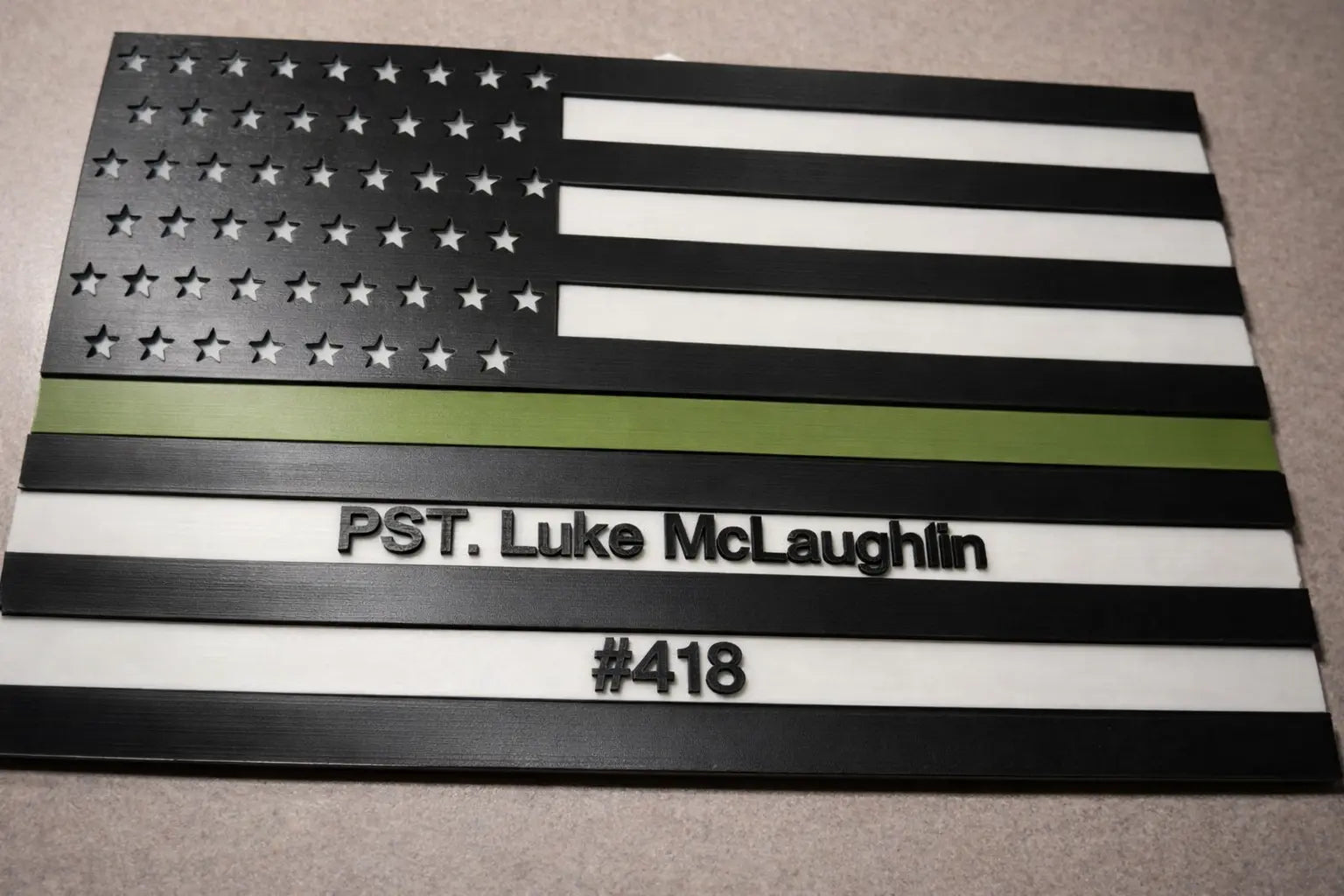 American flag with personalized text on a gray surface