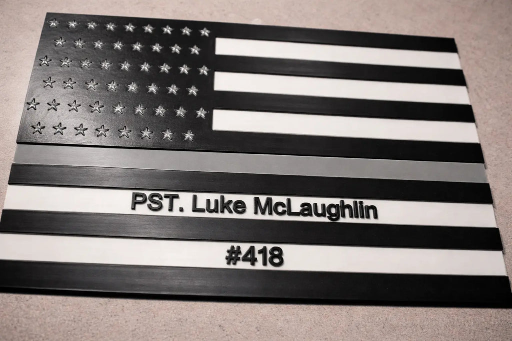 American flag with personalized text on a gray surface