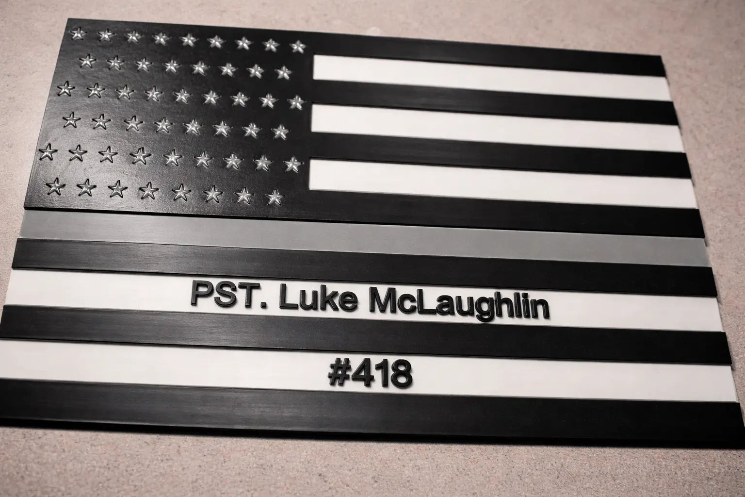 American flag with personalized text on a gray surface